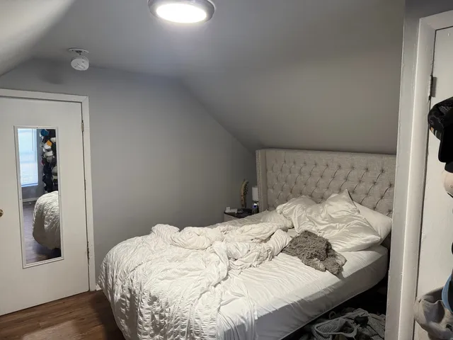 a bedroom with a bed and a window