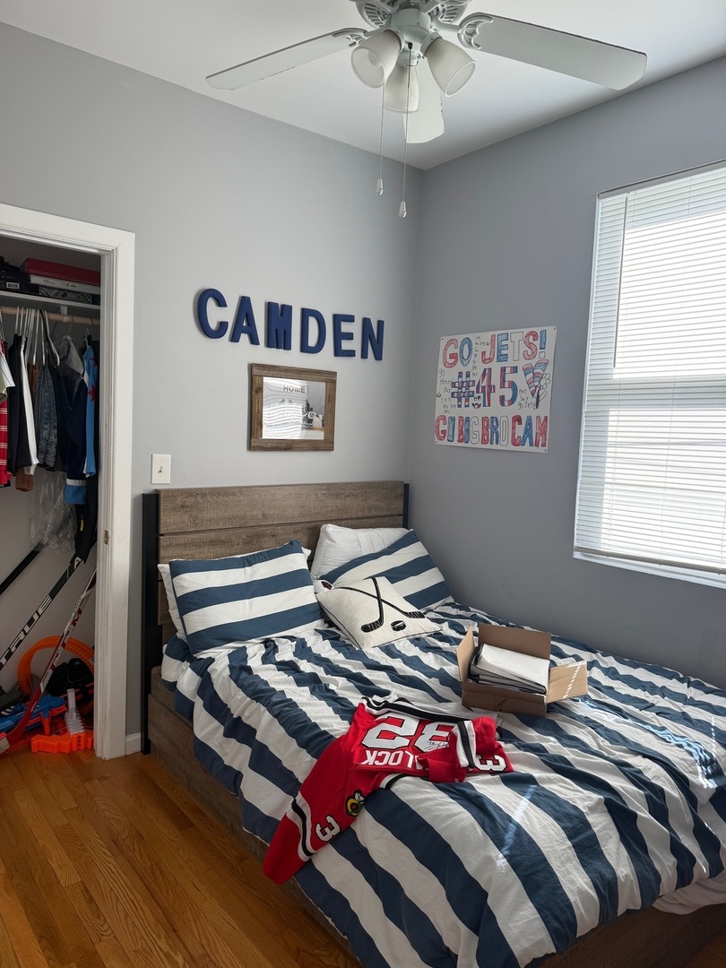 827 North Fairfield Avenue Chicago, IL 60622 - Photo 37 of 55 a bedroom with a bed and a chandelier