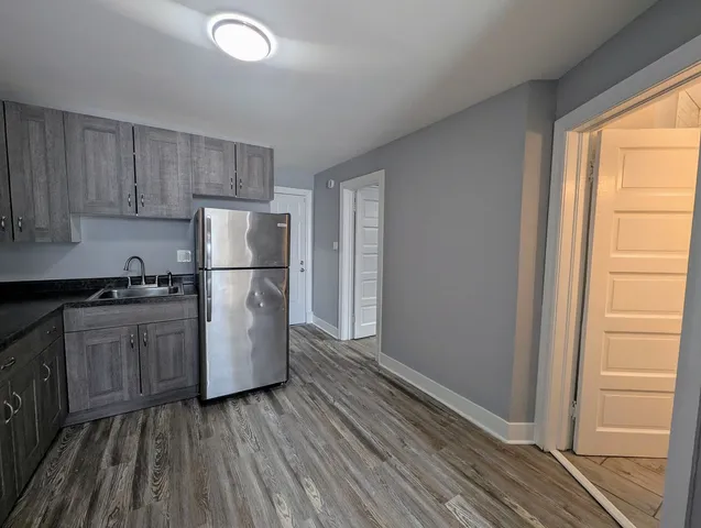 a kitchen with a stove a refrigerator and a sink