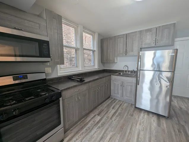 a view of hallway with wooden floor