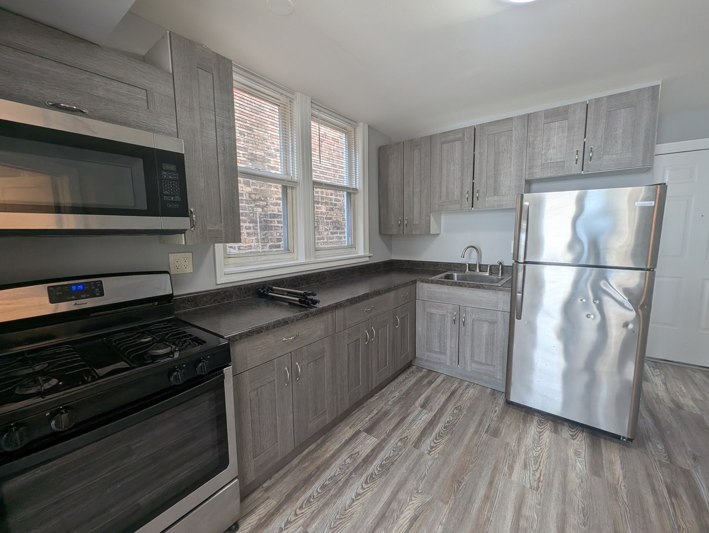 827 North Fairfield Avenue Chicago, IL 60622 - Photo 47 of 55 a kitchen with stainless steel appliances a refrigerator sink and cabinets