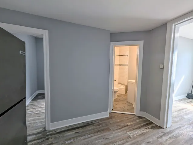 a view of a livingroom with wooden floor and a window