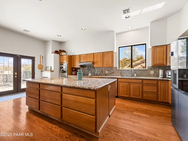 a bed sitting in a spacious bedroom next to a window