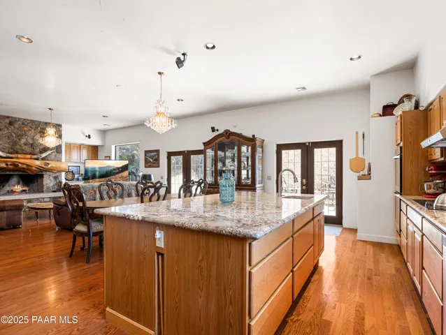 a spacious bathroom with a granite countertop sink and a large mirror