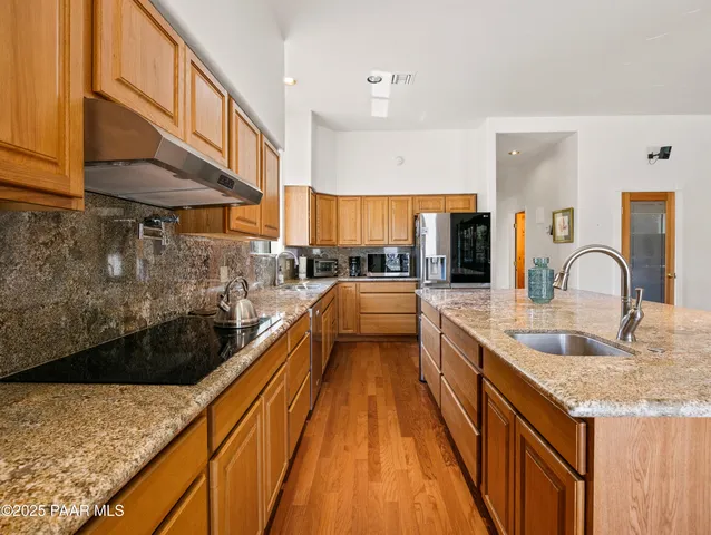 a spacious bathroom with a granite countertop sink and a bathtub
