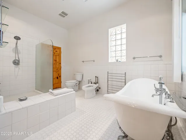 a bathroom with a granite countertop sink mirror and toilet