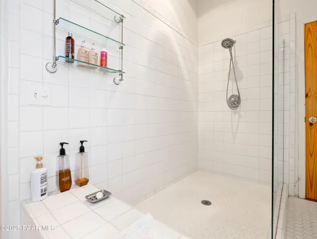 a view of house with yard outdoor seating and trees in the background