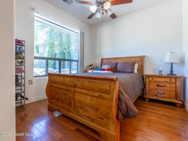 a patio with table and chairs and potted plants