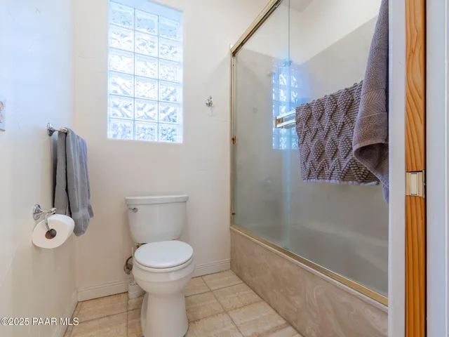 a street view with wooden fence and plants
