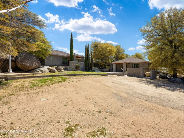 a white house that has a tree in front of it