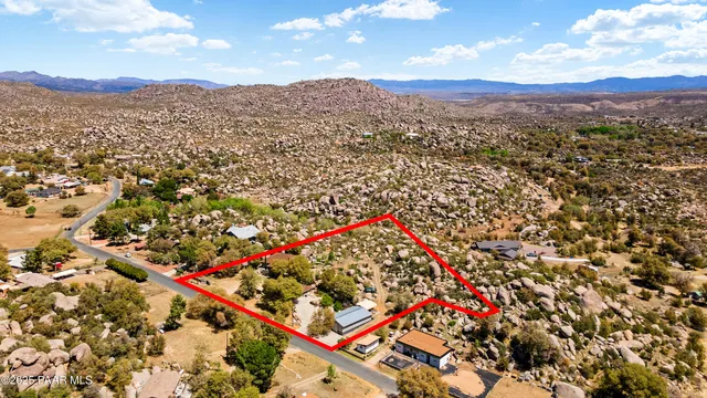 a view of a house with swimming pool and sitting area