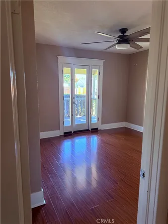 an empty room with wooden floor and a window