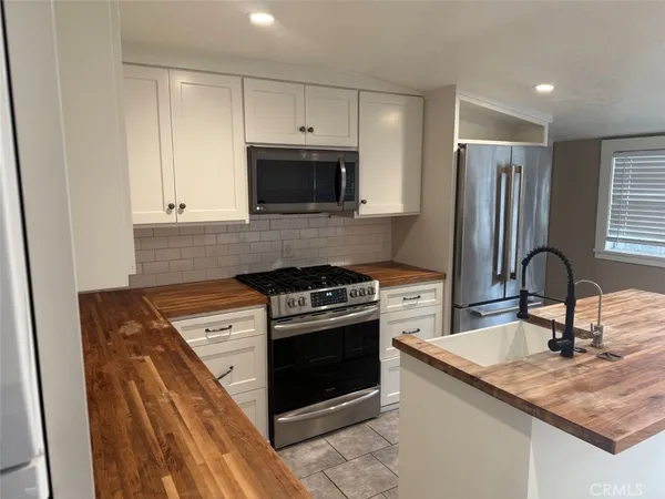 a view of a kitchen with a sink and cabinets