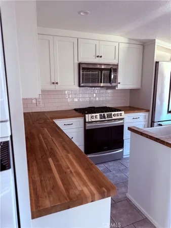 a view of a livingroom with a fireplace wooden floor and a window