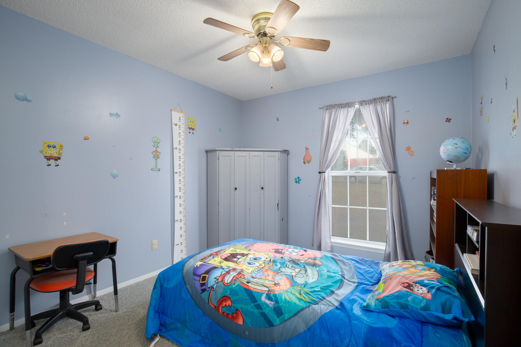 2826 Penney Lane Crestview, FL 32539 - Photo 15 of 22 a bedroom with a bed and a chandelier