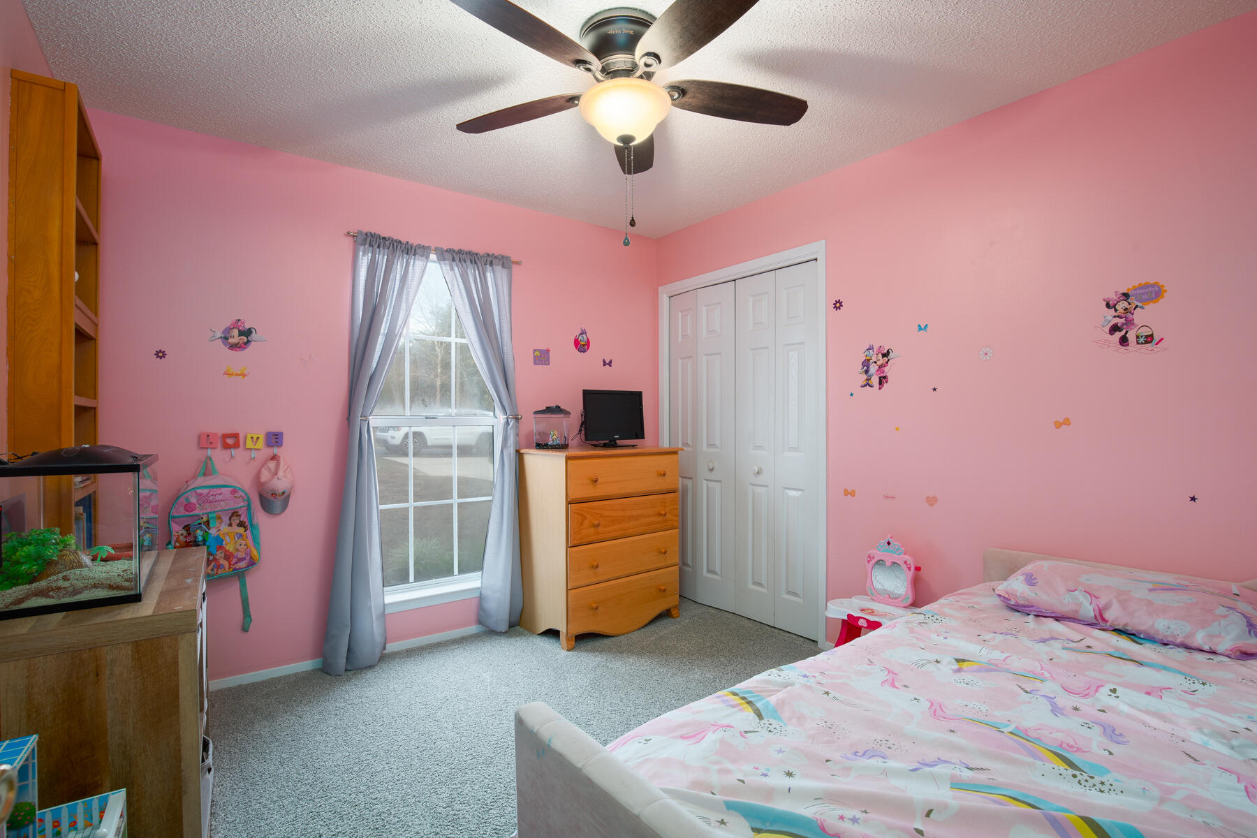 2826 Penney Lane Crestview, FL 32539 - Photo 17 of 22 a bedroom with a bed and a chandelier