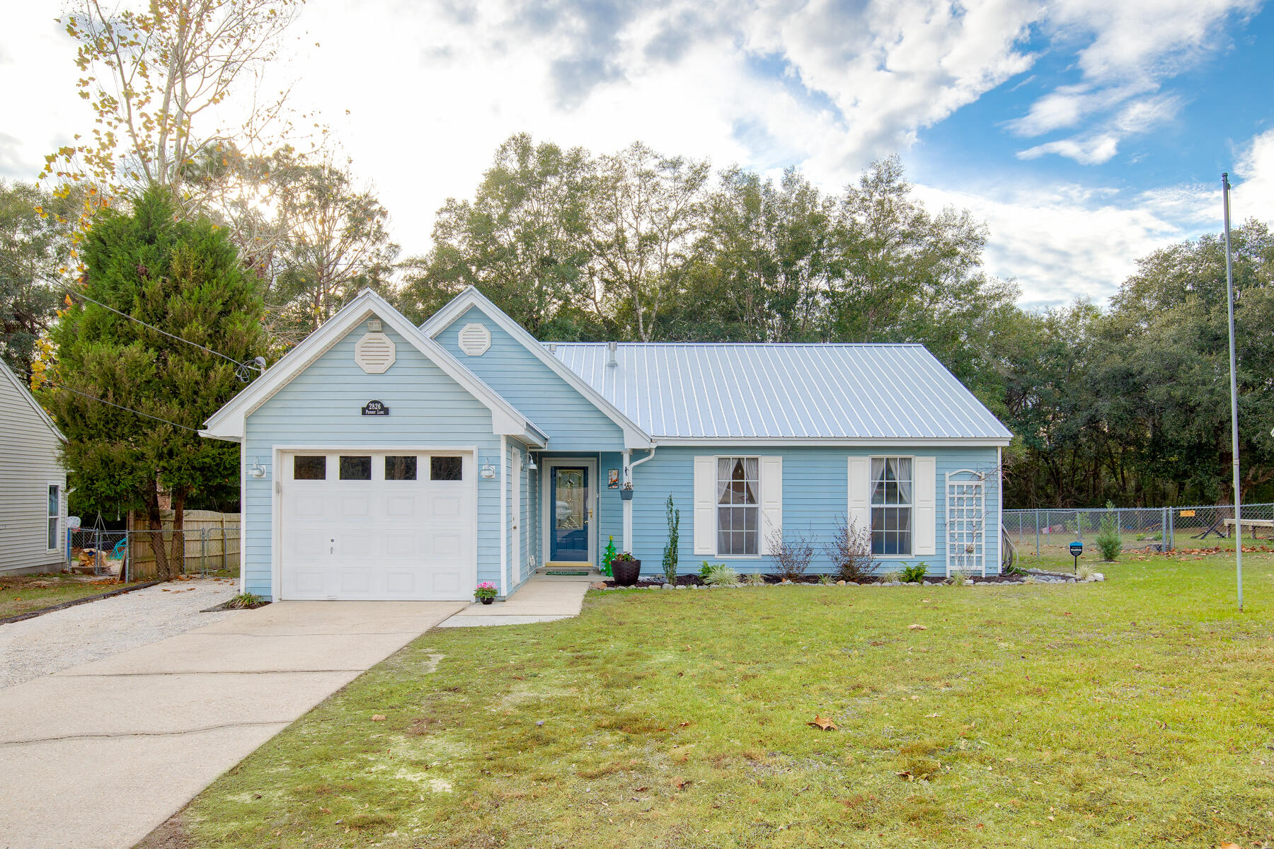 2826 Penney Lane Crestview, FL 32539 - Photo 2 of 22 a view of a house with a yard plants and large tree