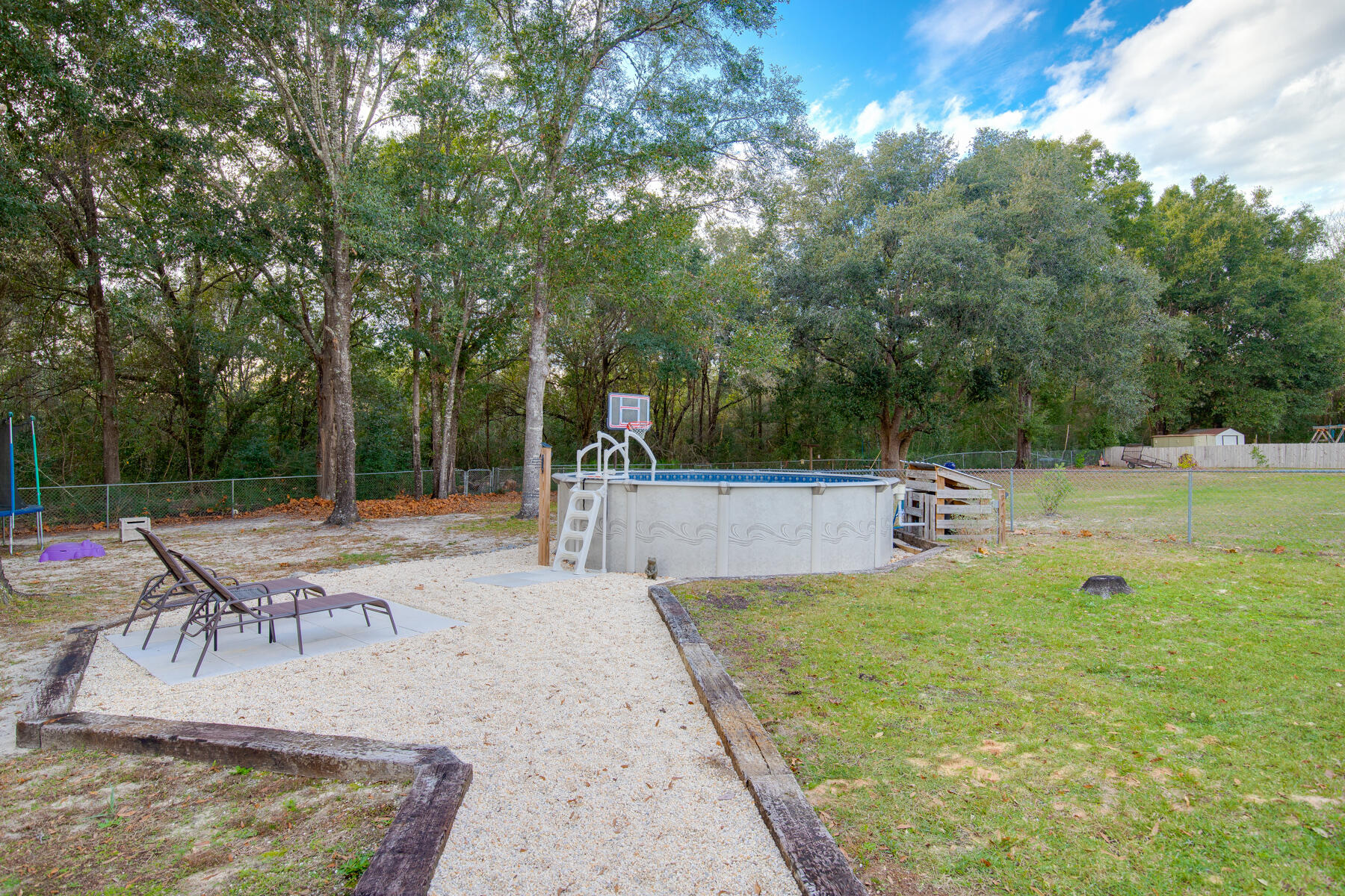 2826 Penney Lane Crestview, FL 32539 - Photo 22 of 22 a view of a swimming pool with chairs