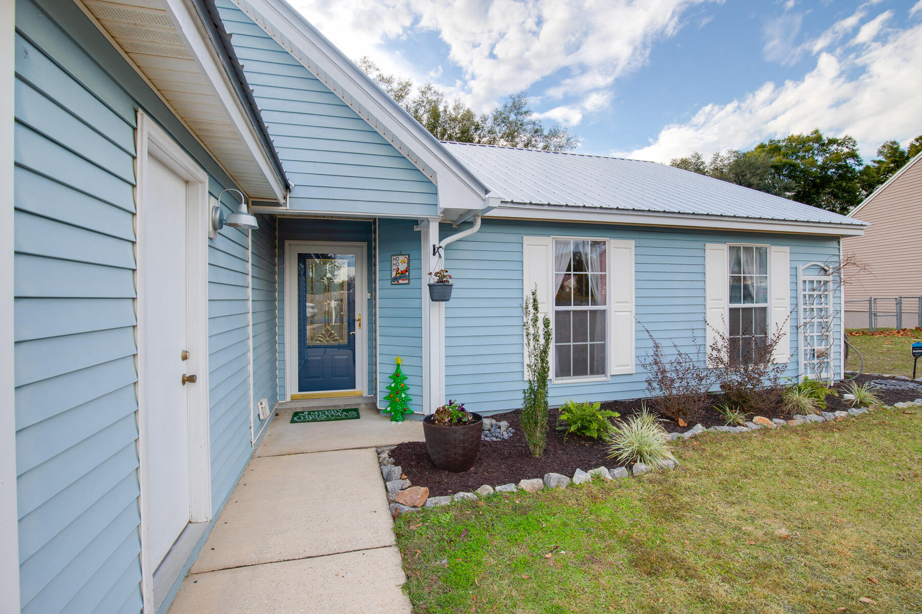 2826 Penney Lane Crestview, FL 32539 - Photo 3 of 22 a front view of a house with garden