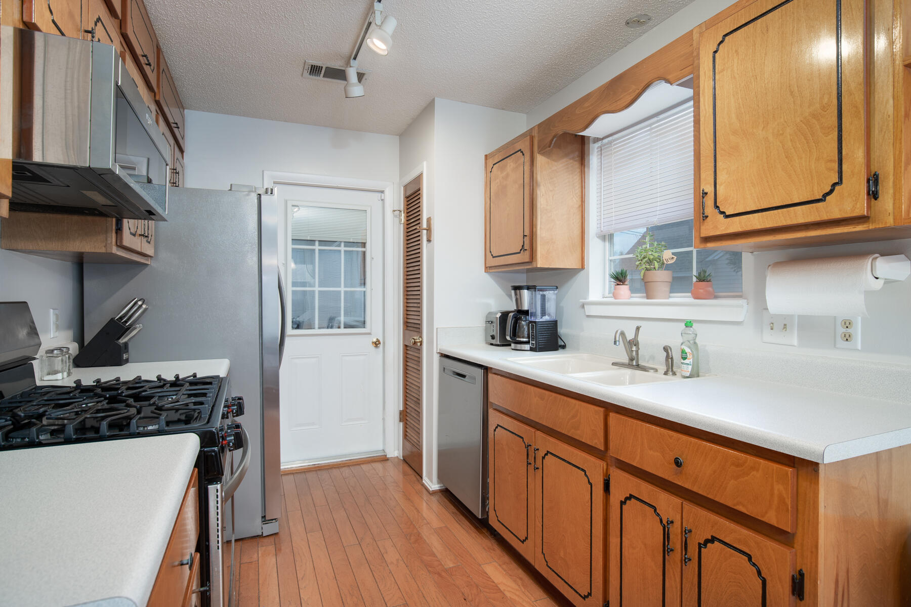 2826 Penney Lane Crestview, FL 32539 - Photo 9 of 22 a kitchen with stainless steel appliances granite countertop a sink stove and refrigerator
