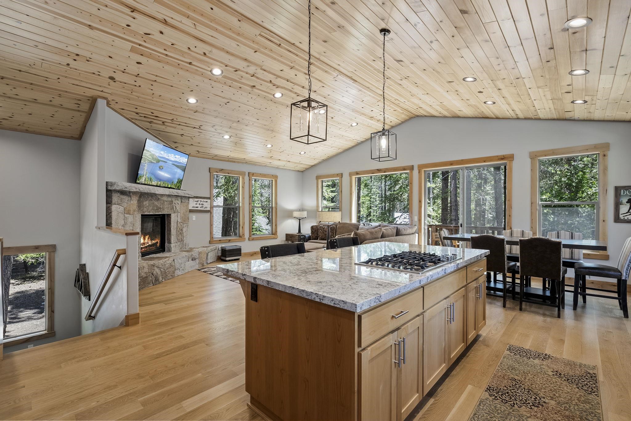 a open kitchen with stainless steel appliances granite countertop a stove and a wooden floors