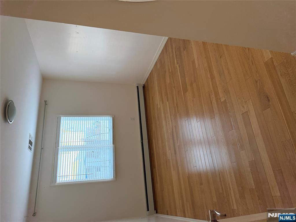 37 Park Row, Unit 2 Wallington, NJ 07057 - Photo 12 of 33 a view of an empty room with wooden floor and a window