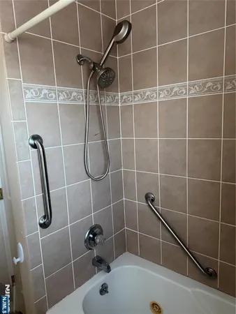 a bathroom with a shower and a sink