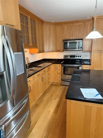 a kitchen with stainless steel appliances a stove a sink and a microwave