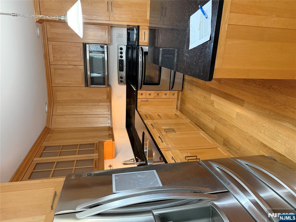 37 Park Row, Unit 2 Wallington, NJ 07057 - Photo 8 of 33 a kitchen with stainless steel appliances a stove a sink and a microwave