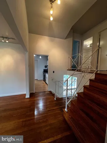 a view of entryway and hall with wooden floor