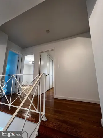a room with wooden floor and staircase