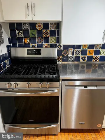 a kitchen with stainless steel appliances granite countertop a stove and a microwave