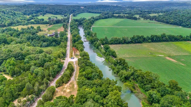an aerial view of a houses with a green yard