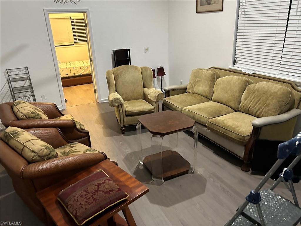 281 Benson Street Naples, FL 34113 - Photo 12 of 21 Living room featuring hardwood / wood-style floors