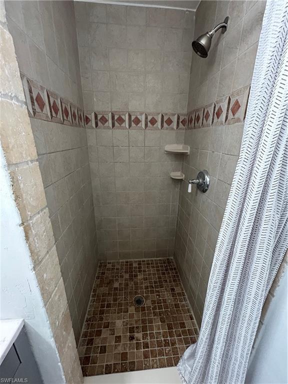 281 Benson Street Naples, FL 34113 - Photo 13 of 21 Bathroom featuring a shower with curtain