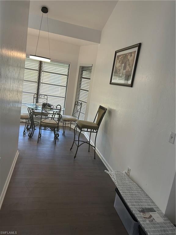281 Benson Street Naples, FL 34113 - Photo 17 of 21 Dining area featuring dark wood-type flooring and lofted ceiling