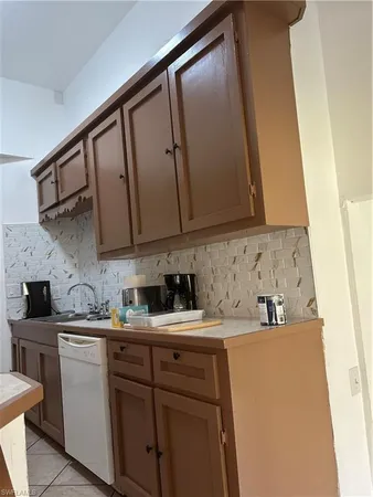 a kitchen with a sink a cabinets and appliances