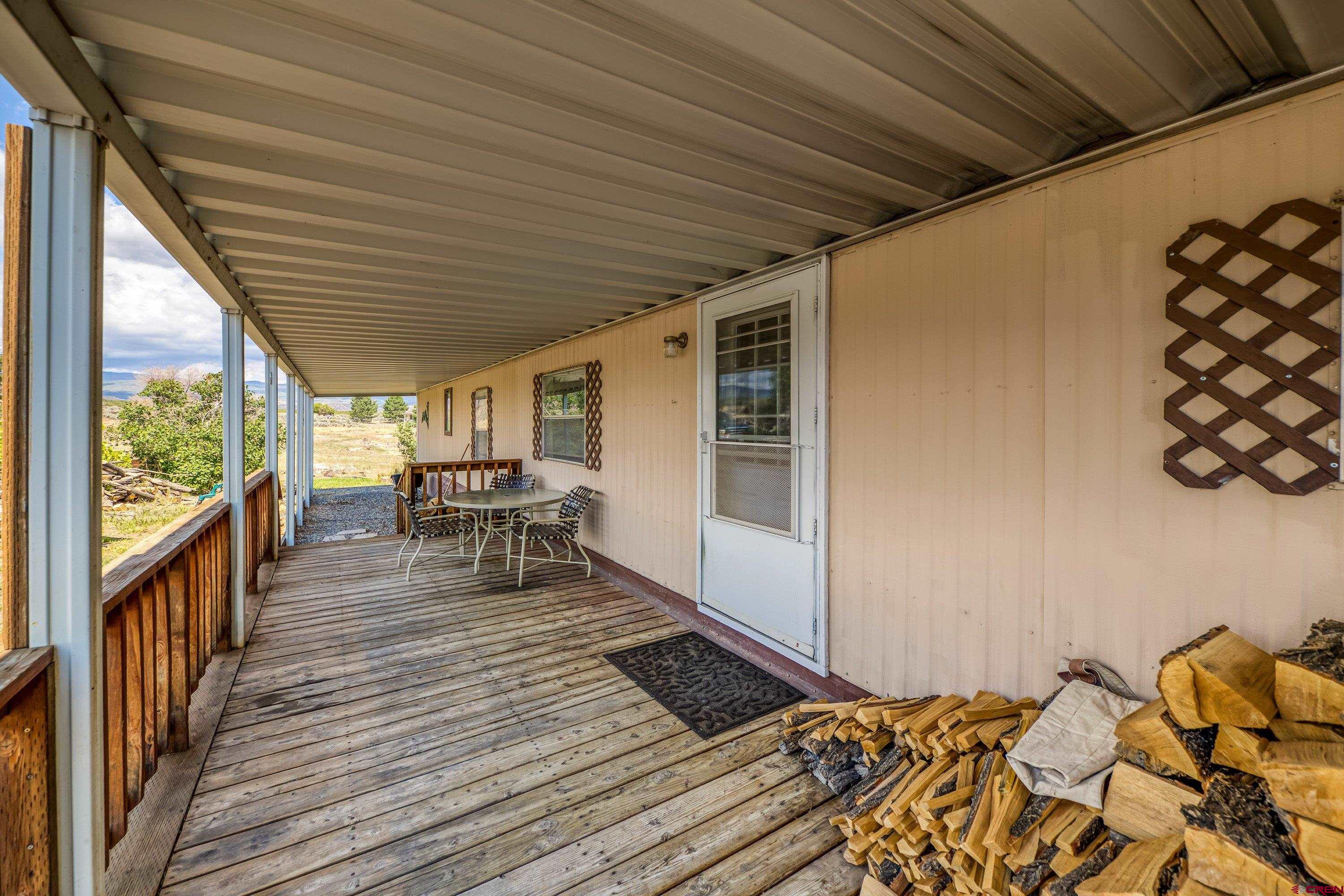 26069 Cedar Mesa Road Cedaredge, CO 81413 - Photo 28 of 29 a view of a patio with wooden floor