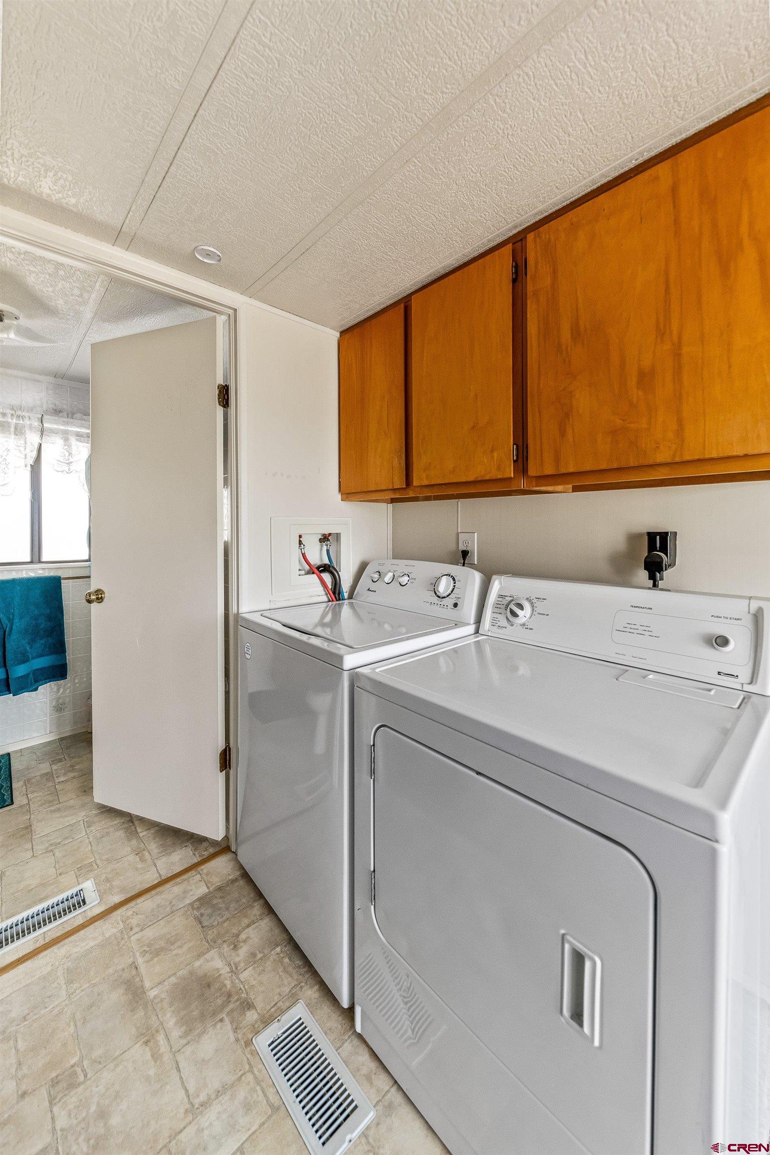 26069 Cedar Mesa Road Cedaredge, CO 81413 - Photo 9 of 29 a room with a sink and a washing machine