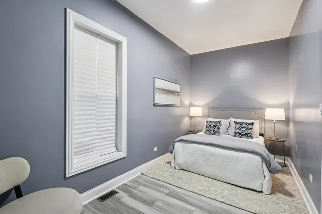 a bathroom with a toilet and a chair