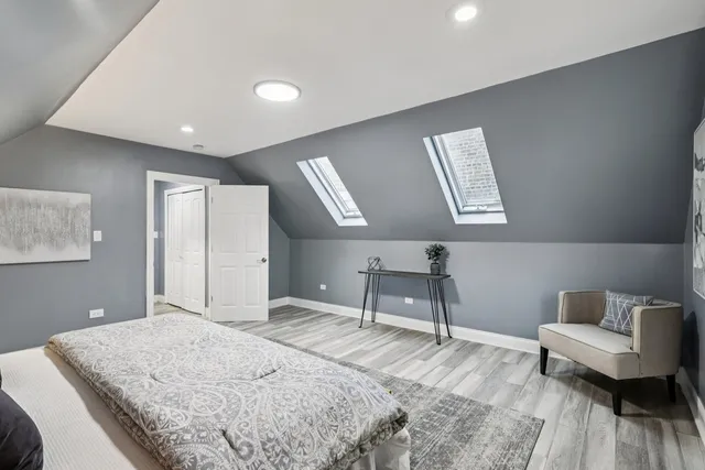 a bedroom with a bed and a night stand