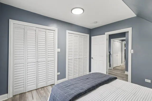 a bathroom with a granite countertop sink and a toilet