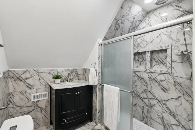 a bathroom with a shower and a glass door