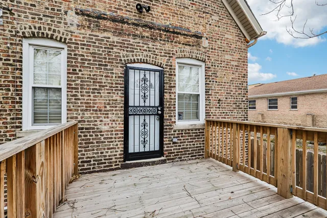 a view of balcony with wooden floor and fence