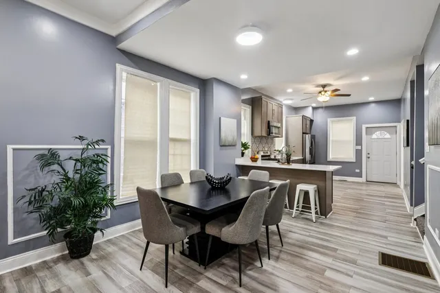 a kitchen with a table chairs sink and refrigerator
