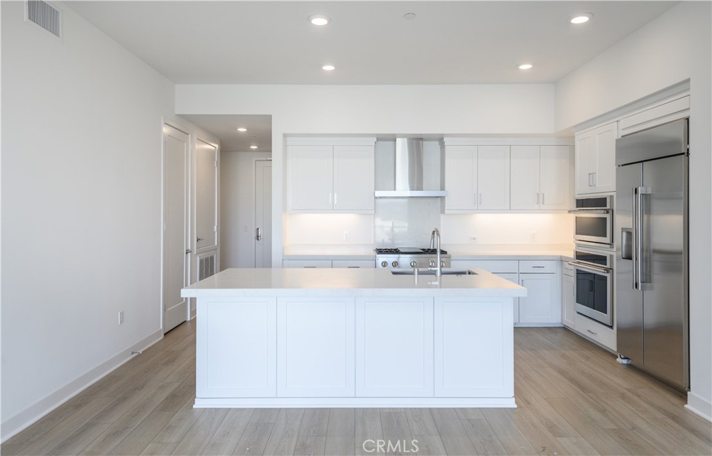 3608 Rivington Irvine, CA 92612 - Photo 16 of 74 a kitchen with stainless steel appliances a sink stove and refrigerator