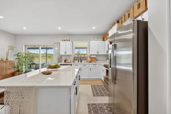 a kitchen with a refrigerator a sink and a stove top oven