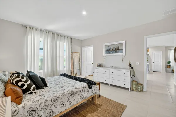 a bedroom with a bed and a dresser