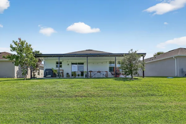 a view of a house with a yard and garage