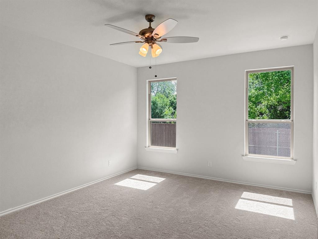 1908 Iris Road Melissa, TX 75454 - Photo 14 of 30 an empty room with windows and chandelier fan